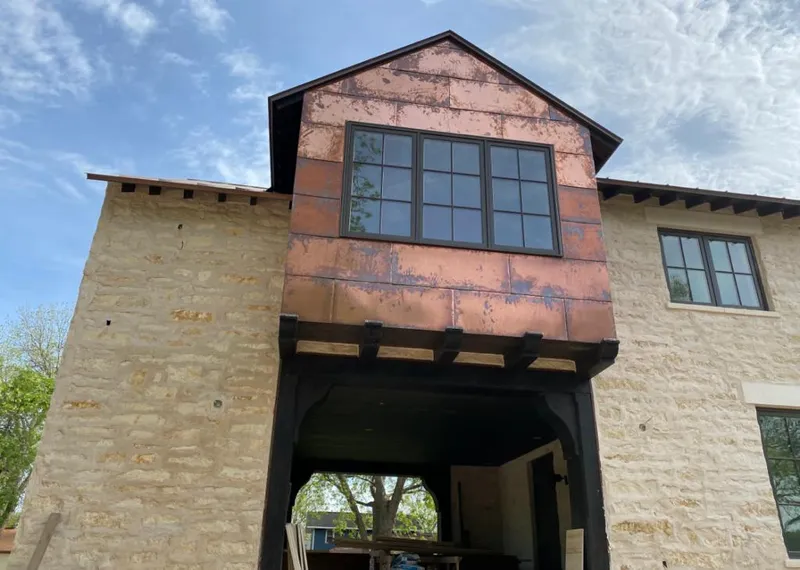 Copper metal panel facade on a stone building for Roof Repair in Sanford